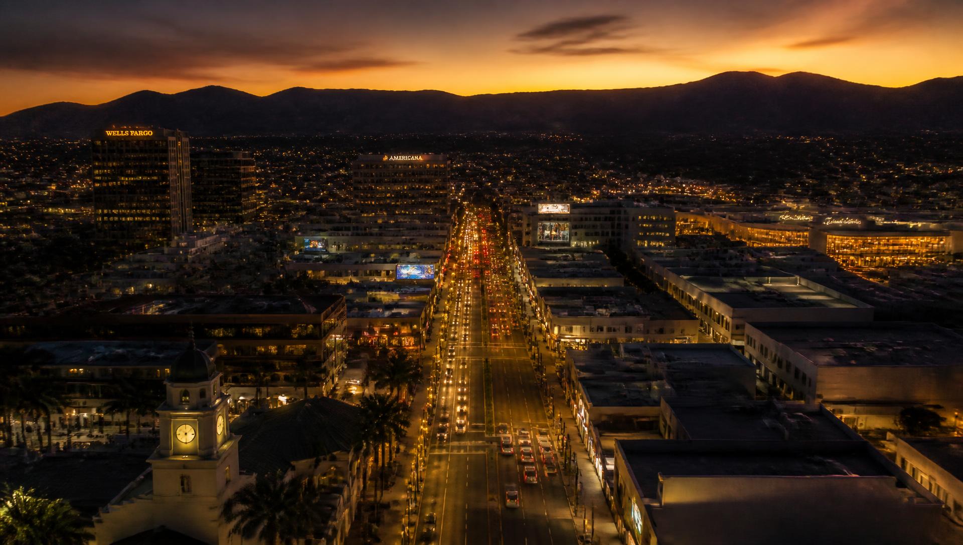 Downtown Glendale at dusk with the San Gabriel Mountains behind